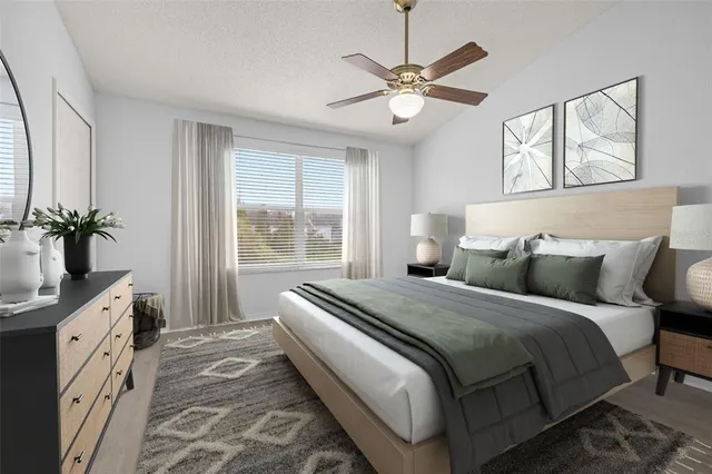 an empty room with wooden floor chandelier fan and windows