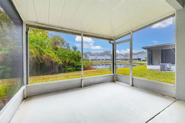 a view of an empty room with a window and outside view