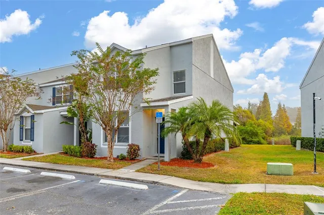 an aerial view of residential houses with outdoor space and swimming pool