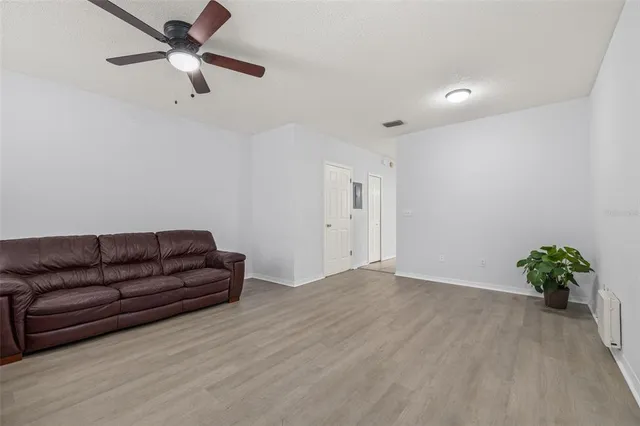 a living room with furniture and a floor to ceiling window