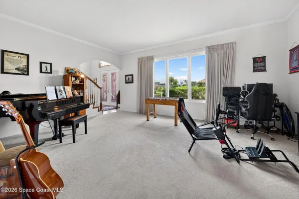 a living room with furniture and paintings on the wall