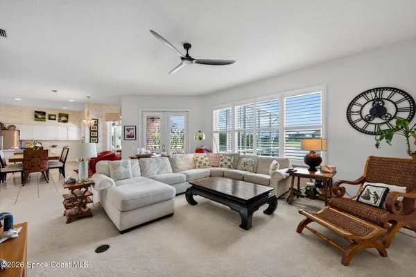 a living room with furniture lamps and wooden floor