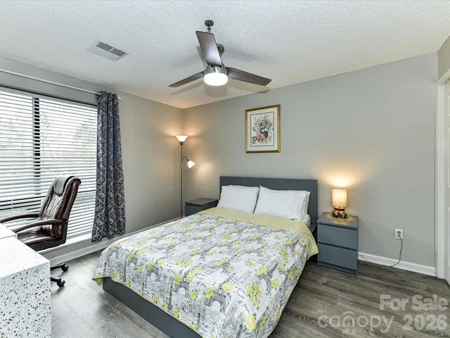 a bedroom with bed and window