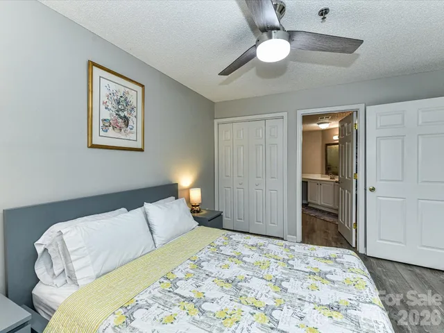 a bedroom with a bed and a chandelier