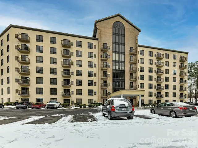 a view of a street that has couple of cars parked in front of it