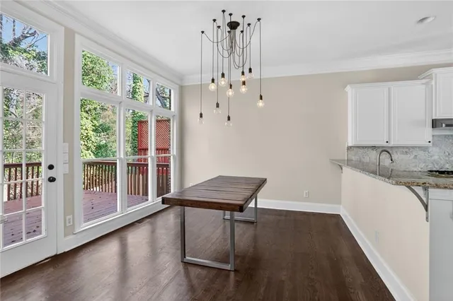 a view of a kitchen with wooden floor and iron stairs