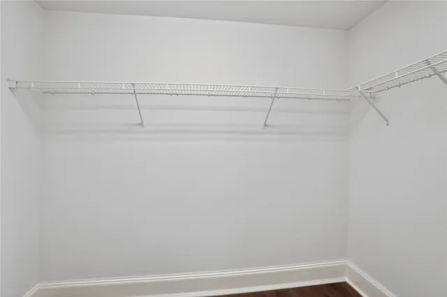 a view of a closet with racks on the wall