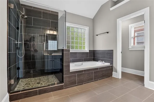 a bathroom with a bathtub and a shower