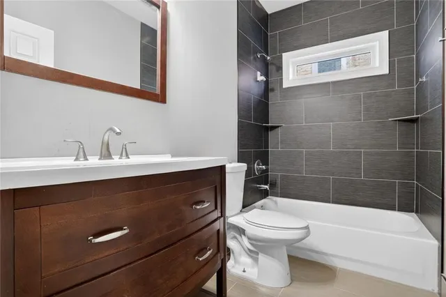 a bathroom with a sink a toilet and bathtub