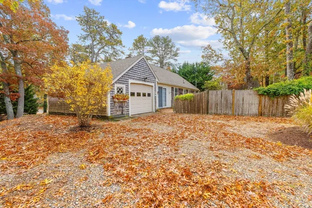 a view of a house with a yard covered in snow