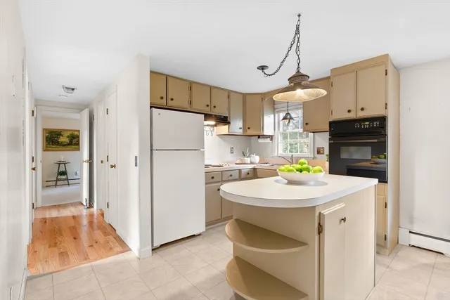 a kitchen that has a refrigerator a sink and a stove