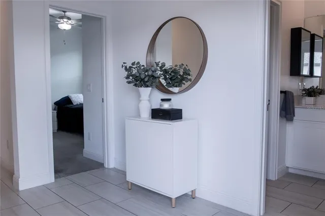 a bathroom with a sink and mirror with bathtub