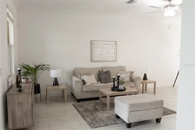 a living room with furniture window and wooden floor