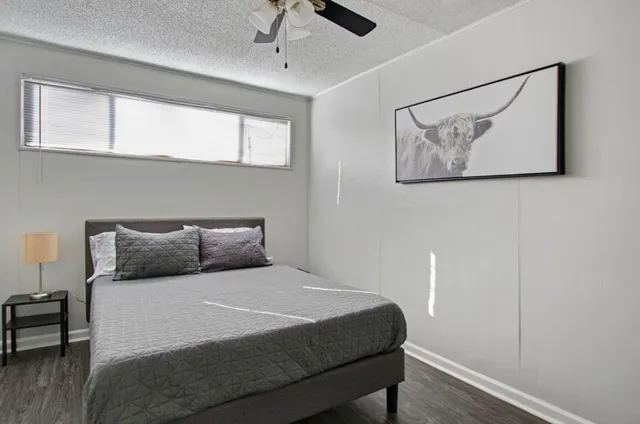 a bedroom with a bed and a ceiling fan