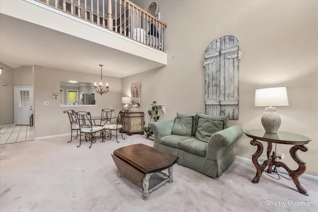 a living room with furniture and a chandelier