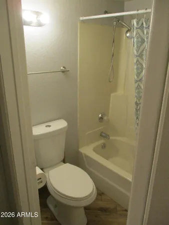 a room with wooden floor and mirror