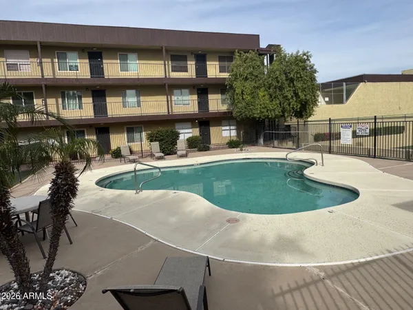 a swimming pool with outdoor seating and yard