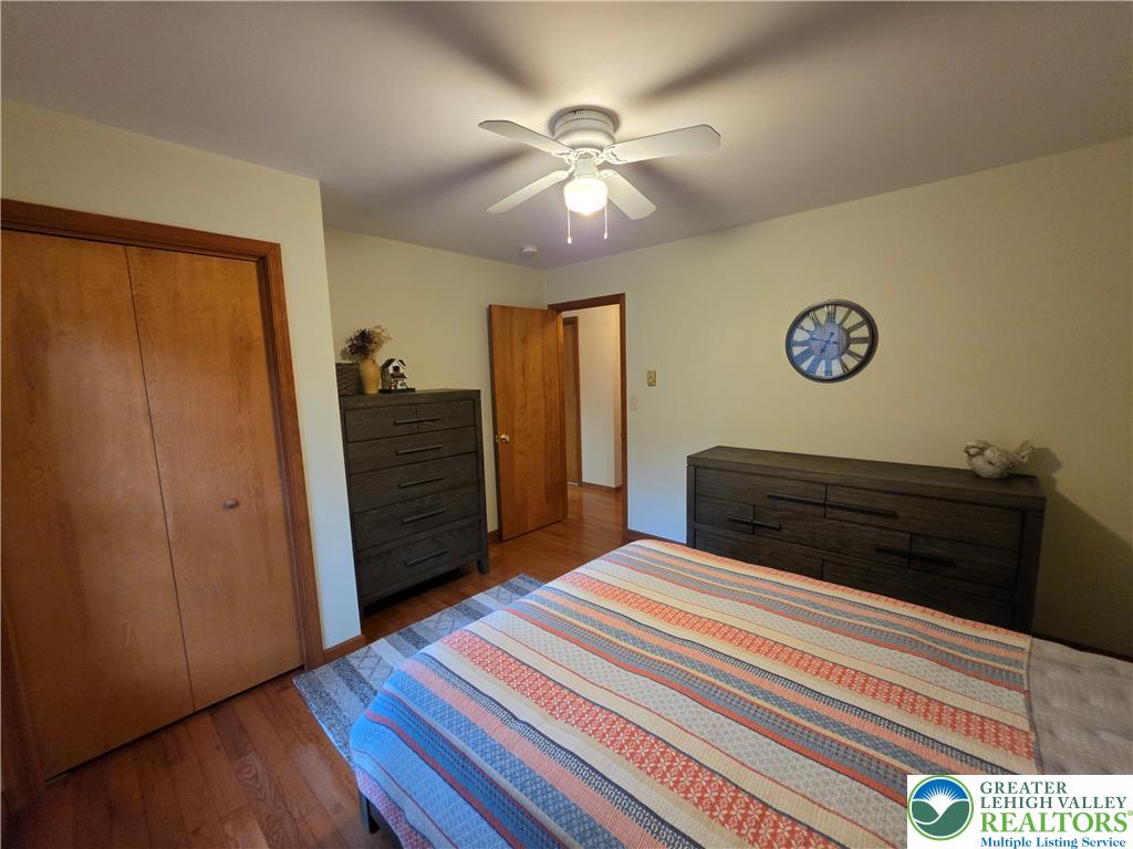 211 Murphy Circle Bushkill, PA 18324 - Photo 18 of 28 Hardwood floors and a ceiling fan enhance this inviting bedroom's comfortable appeal.