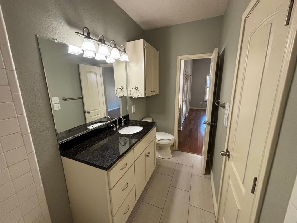 307 Quarry Street San Marcos, TX 78666 - Photo 24 of 38 Half bathroom featuring vanity and light tile patterned floors