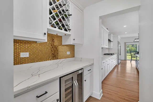 a open kitchen with a sink and wooden floor