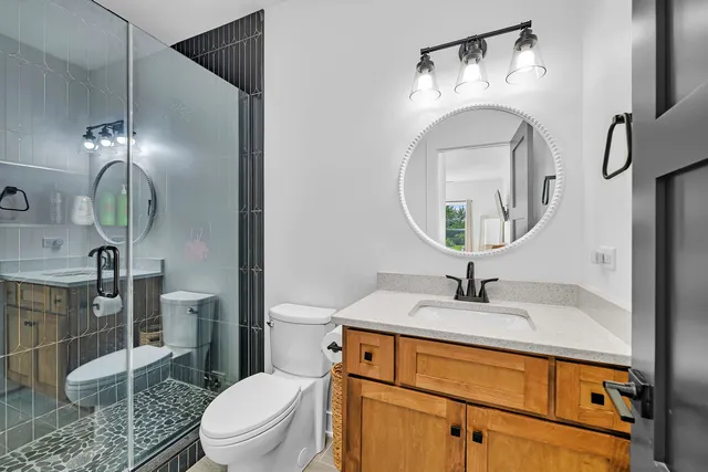 a bathroom with a toilet sink and mirror