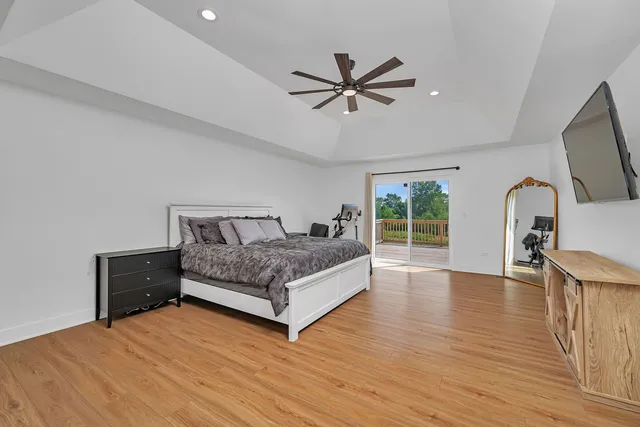 a bedroom with a large bed and a chandelier