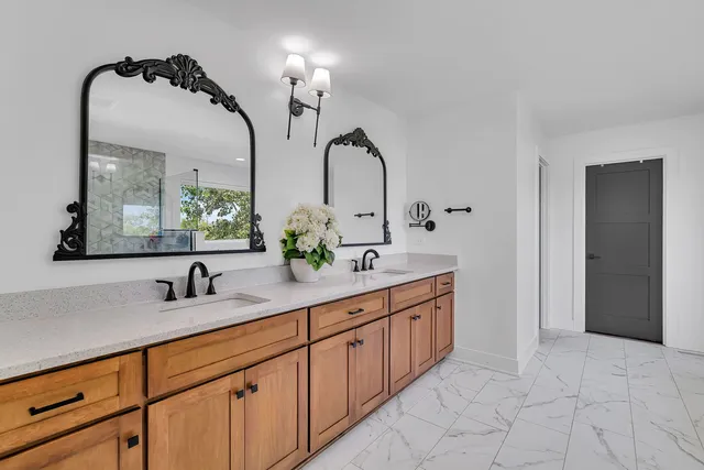 a bathroom with a tub a sink and a large mirror