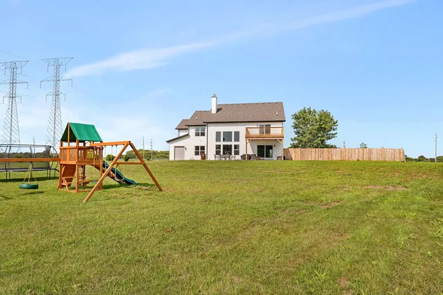 a backyard of a house with barbeque oven table and chairs