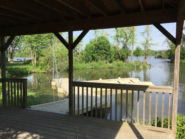 a view of a livingroom with wooden floor and a sink
