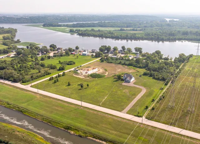 a front view of a house with yard and garage