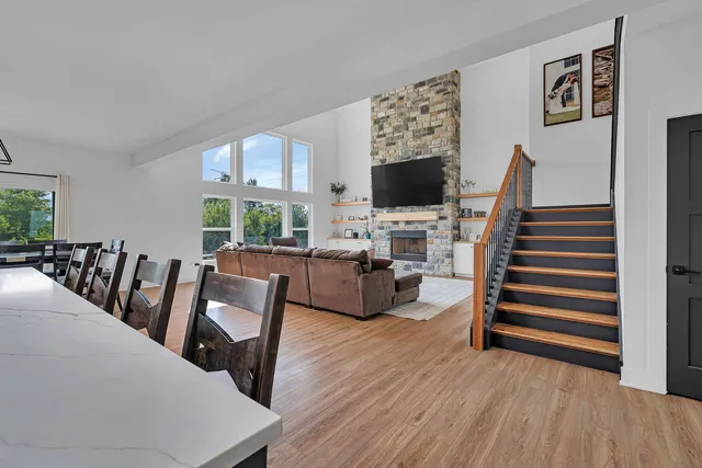a living room with furniture a flat screen tv and a floor to ceiling window