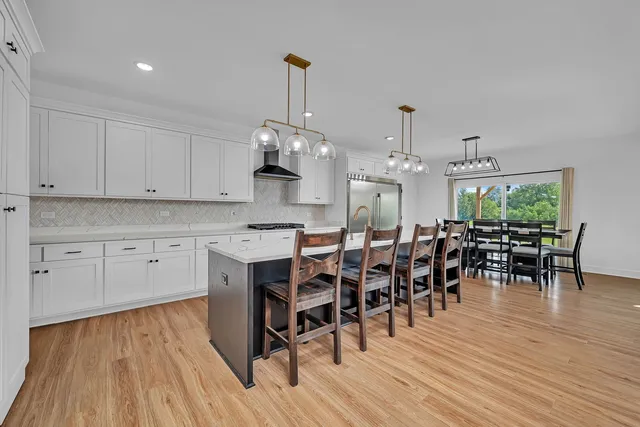 a view of dining table chairs and wooden floor