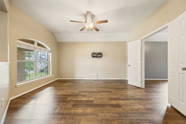 wooden floor in an empty room with a window