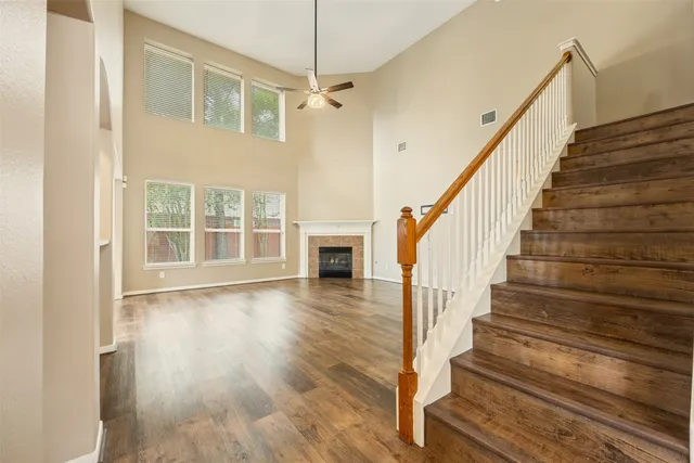 a view of staircase with wooden floor and a front door