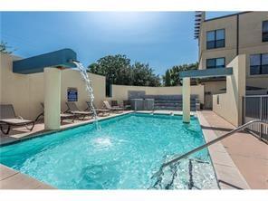4414 Cedar Springs Road, Unit 214 Dallas, TX 75219 - Photo 23 of 29 Community pool with a patio area and a fenced backyard