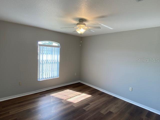 8427 Southwest 136th Street Ocala, FL 34473 - Photo 16 of 18 wooden floor in an empty room with a window