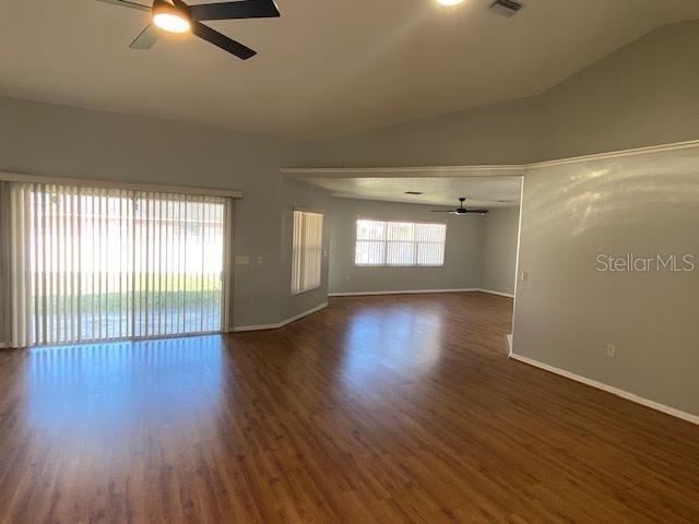 8427 Southwest 136th Street Ocala, FL 34473 - Photo 2 of 18 an empty room with wooden floor and windows