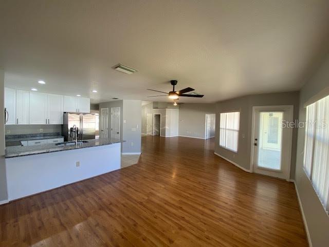 8427 Southwest 136th Street Ocala, FL 34473 - Photo 4 of 18 a view of a kitchen with a sink and wooden floor