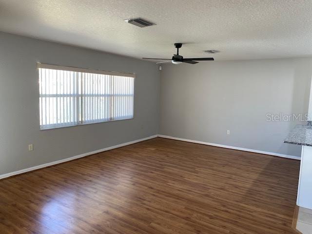 8427 Southwest 136th Street Ocala, FL 34473 - Photo 5 of 18 a view of an empty room with wooden floor and a window