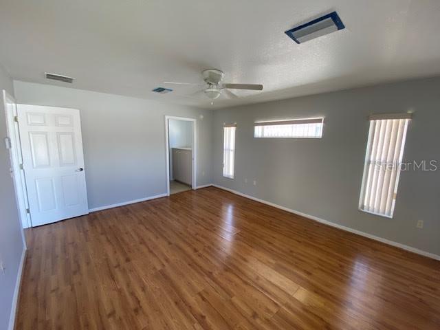 8427 Southwest 136th Street Ocala, FL 34473 - Photo 6 of 18 wooden floor in an empty room with a window