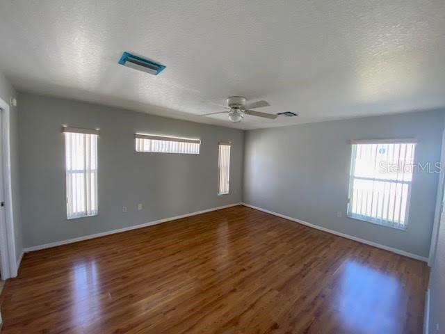 8427 Southwest 136th Street Ocala, FL 34473 - Photo 7 of 18 a view of an empty room with wooden floor and a window