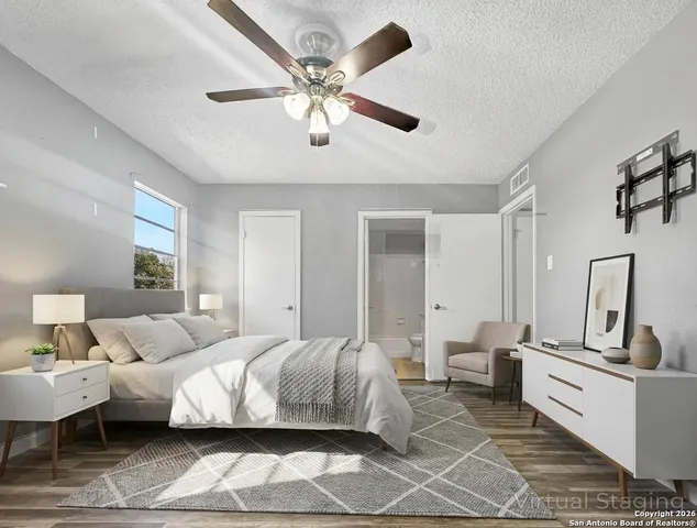 a bedroom with a bed and a potted plant