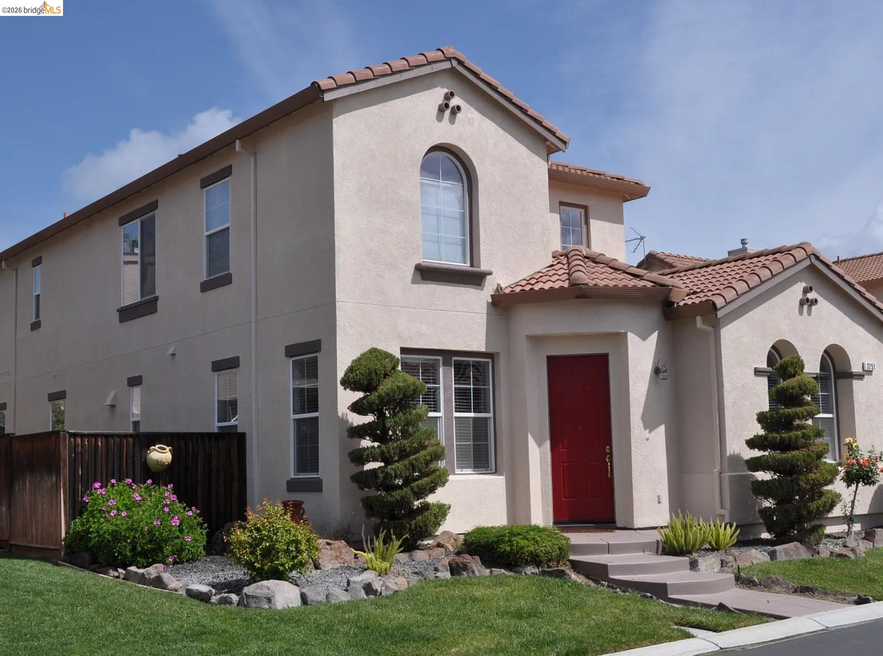 Mediterranean / spanish-style home with stucco siding and a tiled roof