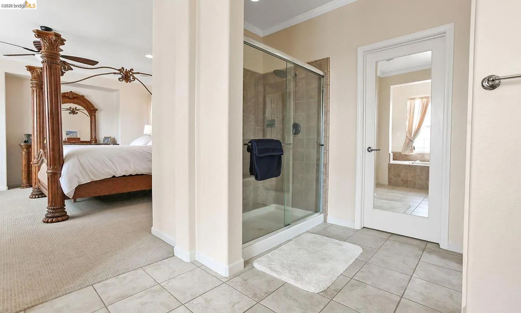 3251 Lookout Point Loop Discovery Bay, CA 94505 - Photo 17 of 31 Ensuite bathroom featuring ornamental molding, a stall shower, light tile patterned flooring, light colored carpet, and a ceiling fan
