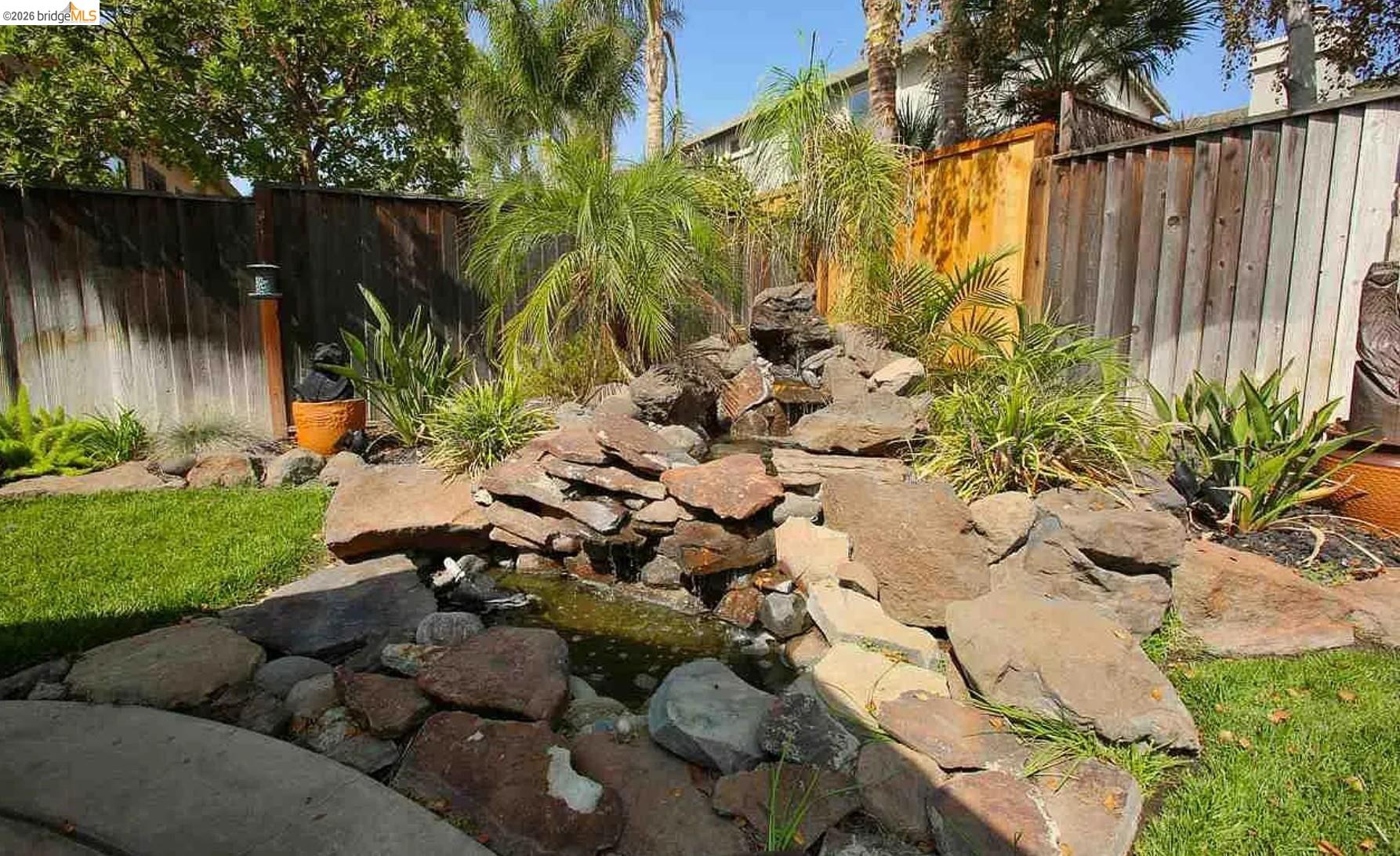 3251 Lookout Point Loop Discovery Bay, CA 94505 - Photo 25 of 31 Fenced backyard featuring a small pond