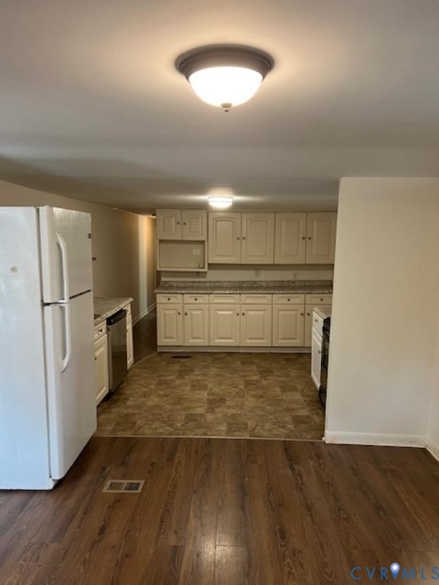 415 Garretts Mill Road Mineral, VA 23117 - Photo 22 of 43 a view of a refrigerator in kitchen and an empty room with wooden floor