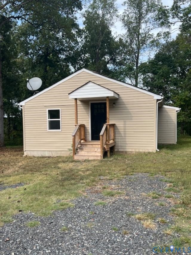 415 Garretts Mill Road Mineral, VA 23117 - Photo 6 of 43 a view of a white house with a small yard and large tree