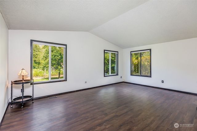 a view of room with window and wooden floor