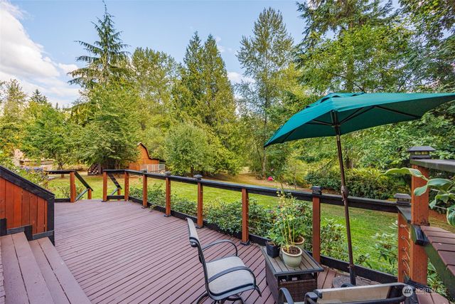a view of a balcony with chairs and wooden floor