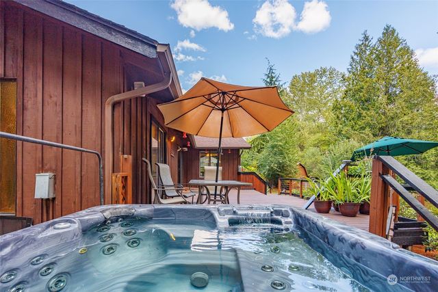 a view of a house with backyard and sitting area